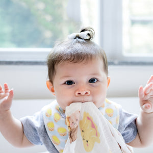 cute baby biting dim sum swaddle