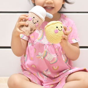 little girl playing with the wee bean fair-trade rattle dolls in boba and siu mai