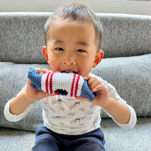 toddler child playing with the wee bean handmade fairtrade rattle doll in white rabbit bunny candy