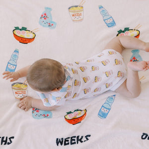 baby doing tummy time in the wee bean organic cotton onesie bodysuit in cup noodle