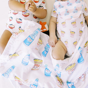 close up of the wee bean minky fleece sensory baby blanket in cup noodle and ramune soda