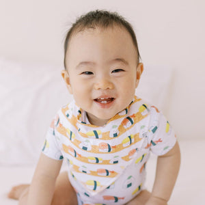 cute happy baby in the wee bean organic cotton bib in sushi