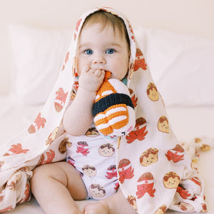 cute baby chewing on the wee bean fair-trade handmade dolls in shrimp ebi sushi