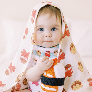 cute baby wearing the wee bean takoyaki swaddle and bib set